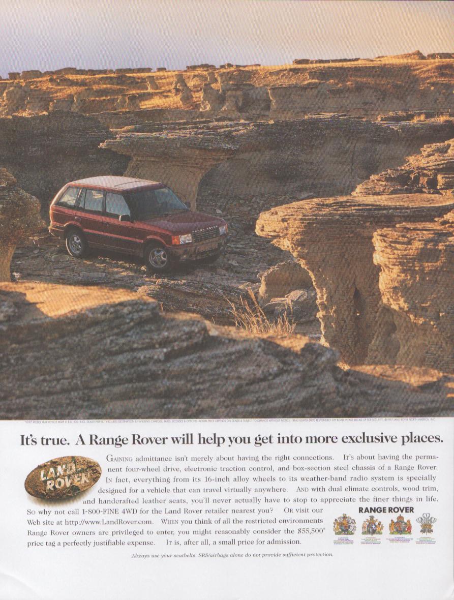 Vintage 1990s Land Rover Range Rover original print advertisement, red Range Rover navigating dramatic canyon badlands terrain in golden desert light