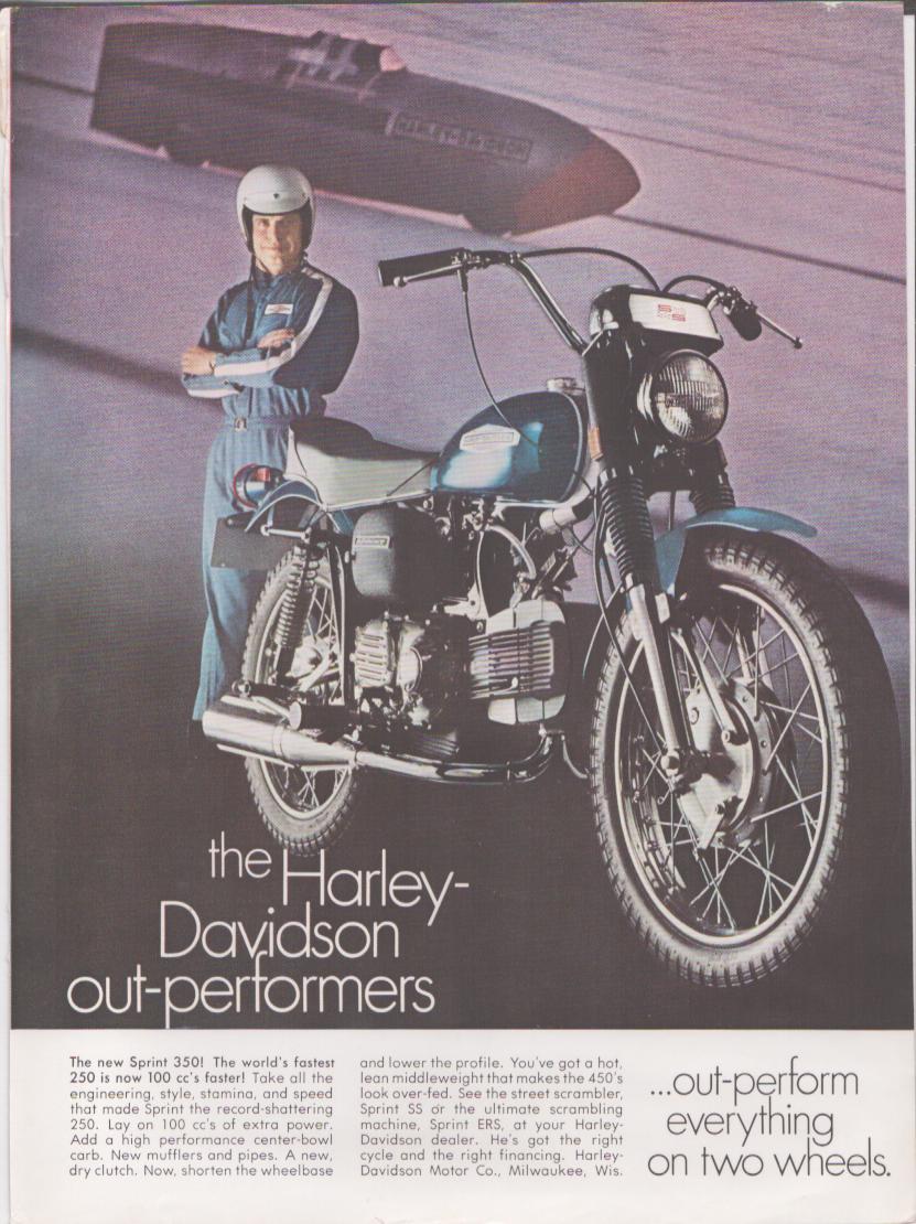 Vintage 1968 Harley-Davidson Sprint 350 original print advertisement, helmeted rider in blue racing suit posed beside scrambler motorcycle on salt flats backdrop