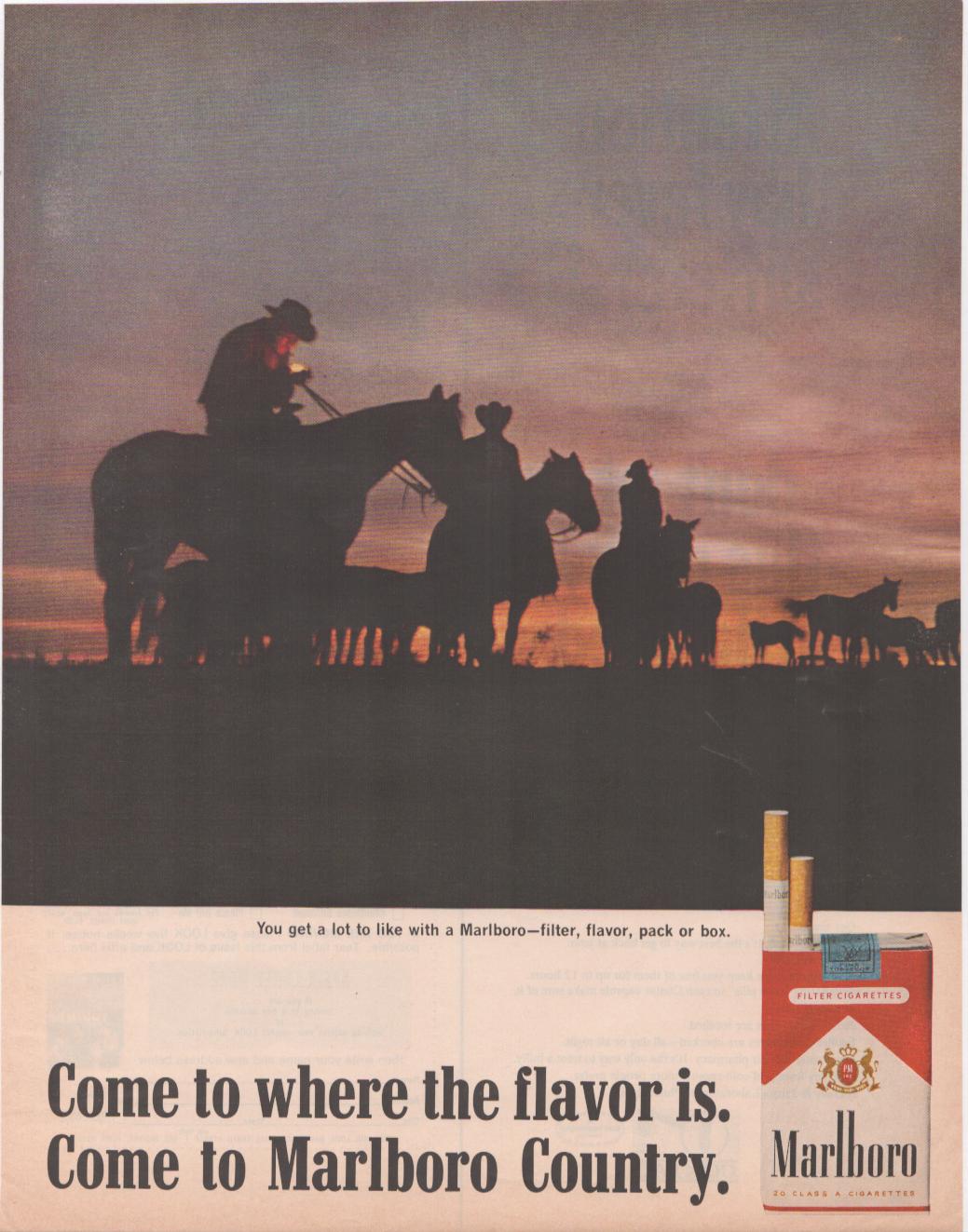 Vintage 1960s Marlboro Cowboy original print advertisement, two cowboys on horseback silhouetted against a fiery sunset with a herd of horses, Come to Marlboro Country tagline
