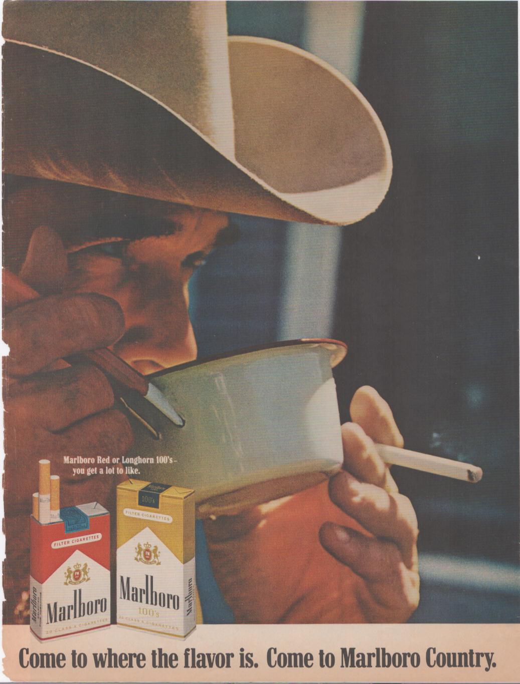 Vintage 1970s Marlboro Cowboy original print advertisement, close-up of cowboy in cream Stetson holding tin coffee cup with cigarette, Marlboro Red and 100s packs shown at bottom