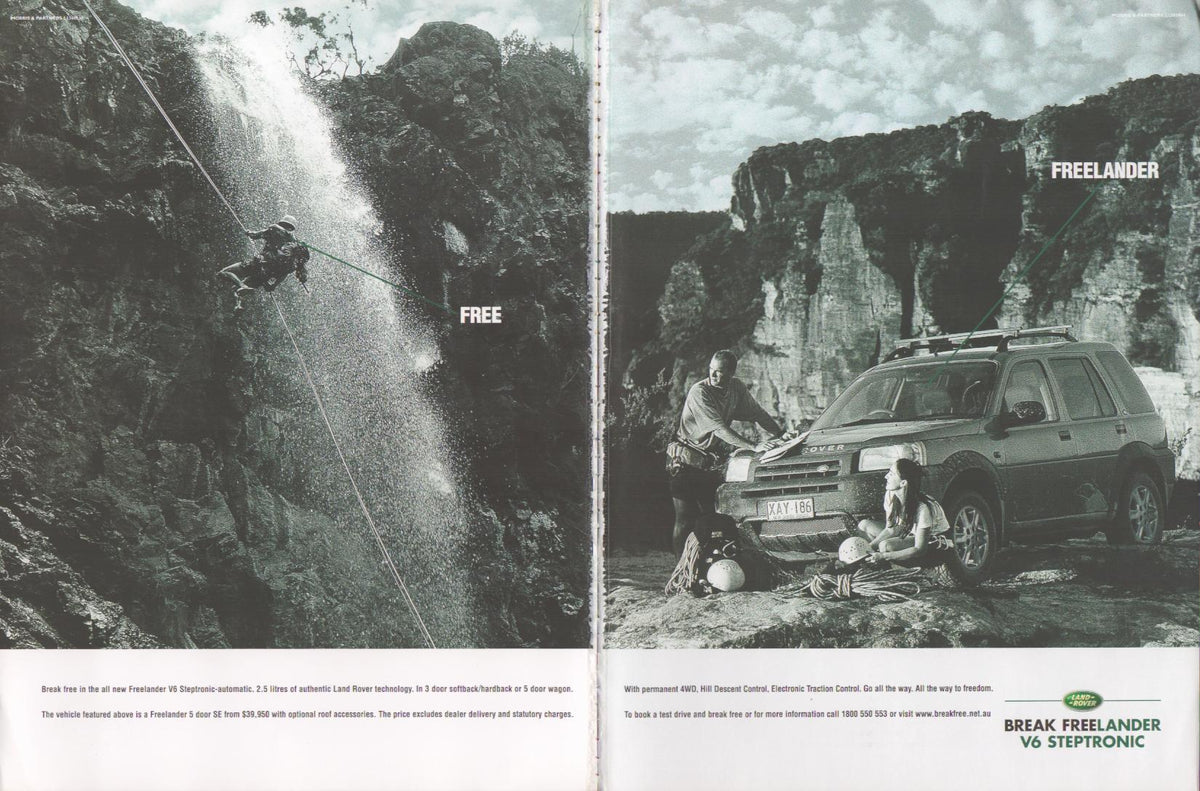 Vintage 2000s Land Rover Freelander V6 Steptronic original print advertisement, black-and-white two-page spread with rock climbers rappelling waterfall and Freelander parked in canyon