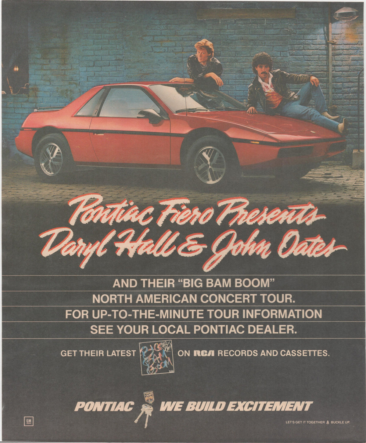 Vintage 1984 Pontiac Fiero original print advertisement featuring Daryl Hall and John Oates posed on a red Fiero against a brick wall backdrop, promoting their Big Bam Boom concert tour