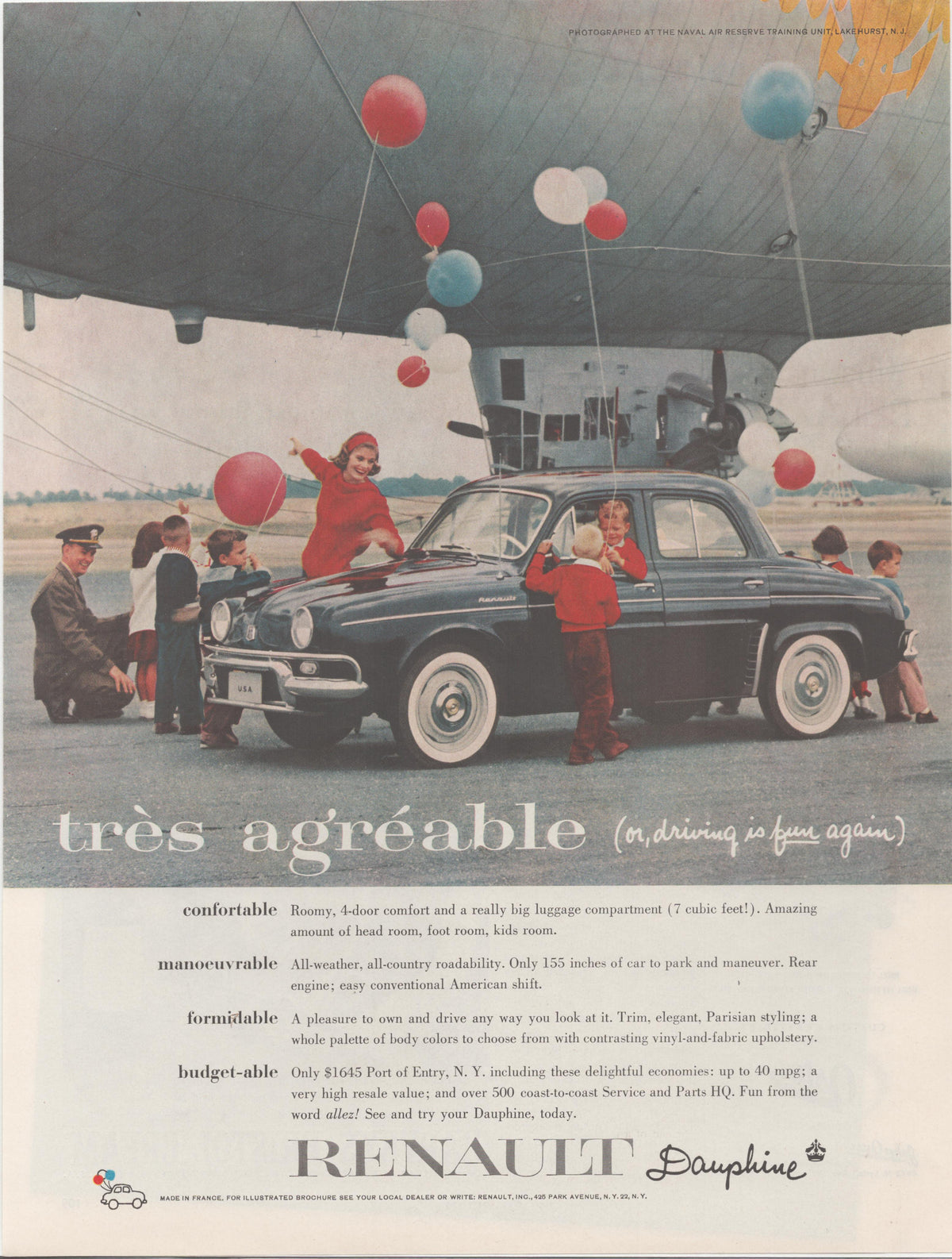 Vintage 1959 Renault Dauphine original print advertisement, dark blue sedan photographed on tarmac beneath a large airship at Lakehurst NJ with children and colorful balloons