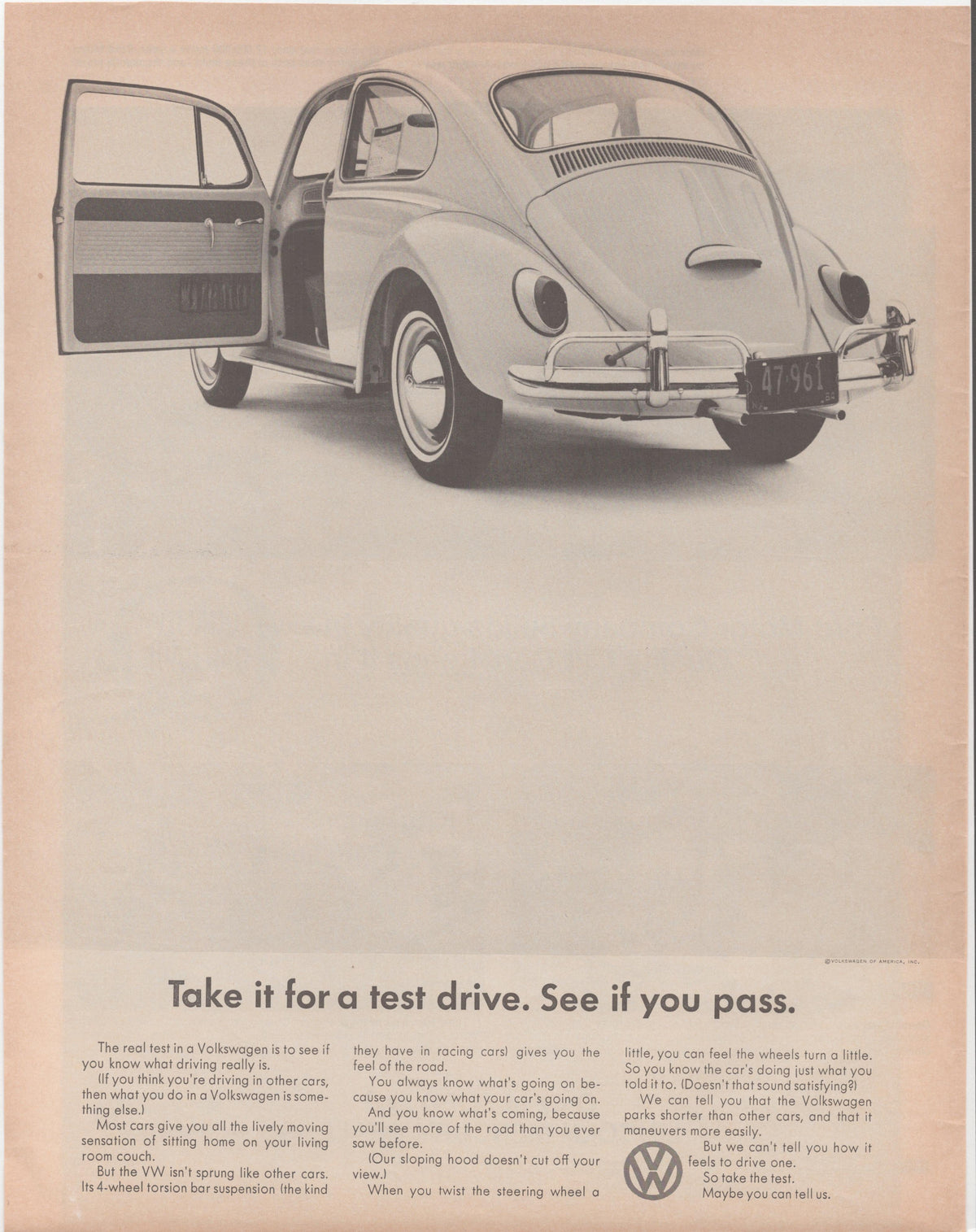Vintage 1960s Volkswagen Beetle original print advertisement, black and white rear three-quarter view of VW Bug with door open, headline reads Take it for a test drive. See if you pass.