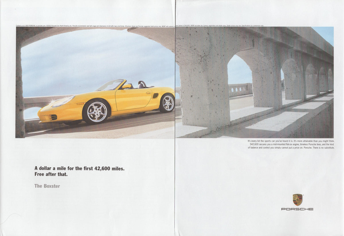 Vintage 1990s Porsche Boxster original print advertisement, yellow convertible roadster framed beneath concrete arches on a coastal road, two-page spread