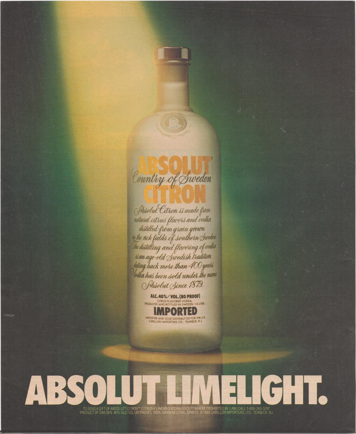 Vintage 1989 Absolut Citron original print advertisement, bottle dramatically lit by stage spotlights against dark green background with 'Absolut Limelight' tagline