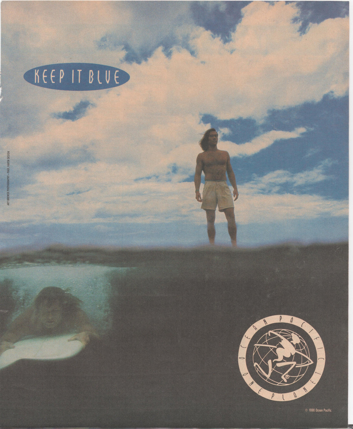 Vintage 1990 Ocean Pacific Keep It Blue original print advertisement, surfer standing atop a wave with underwater figure visible below and dramatic cloudy sky