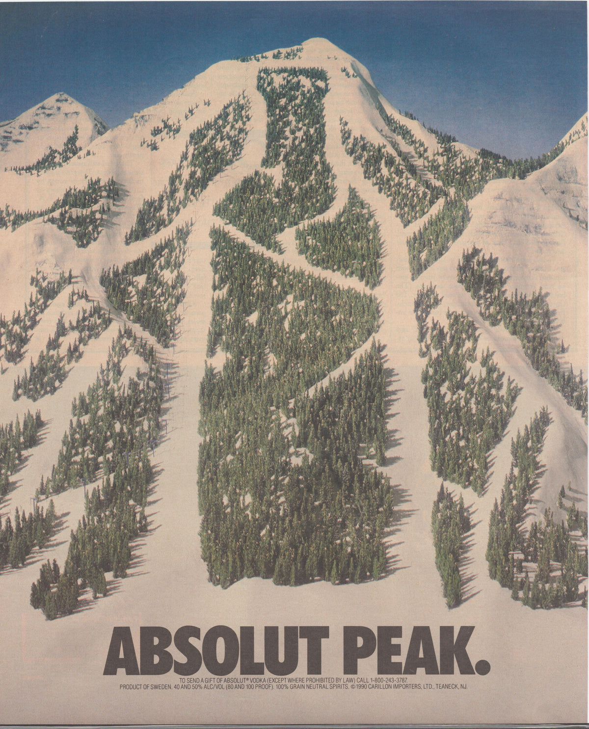 Vintage 1990 Absolut Vodka Peak original print advertisement, aerial view of snow-covered mountain with tree-lined ski runs forming bottle shape