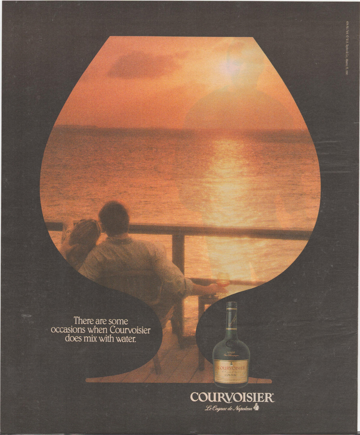Vintage 1970s Courvoisier VSOP Cognac original print advertisement, couple on balcony watching ocean sunset framed within brandy snifter silhouette with bottle below