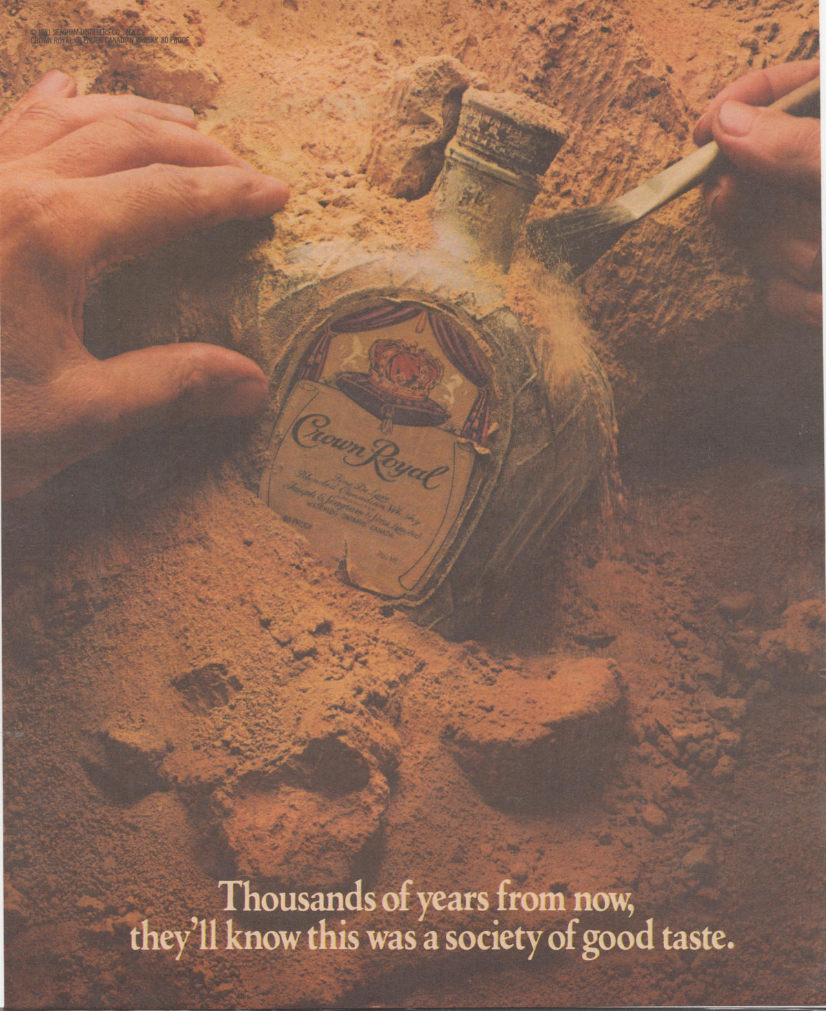 Vintage 1981 Crown Royal Canadian whisky original print advertisement, hands with brush unearthing Crown Royal bottle from sandy soil with tagline 'Thousands of years from now, they'll know this was a society of good taste'