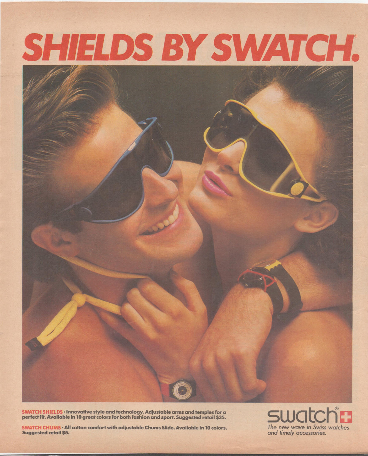 Vintage 1980s Swatch Shields original print advertisement, two models wearing colorful oversized shield sunglasses and Swatch watches in a close romantic pose