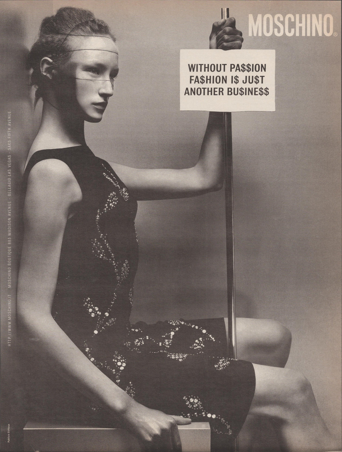 Vintage 1990s Moschino original print advertisement, black and white editorial image of a model in a beaded black dress holding a placard reading 'Without Passion Fashion Is Just Another Business'