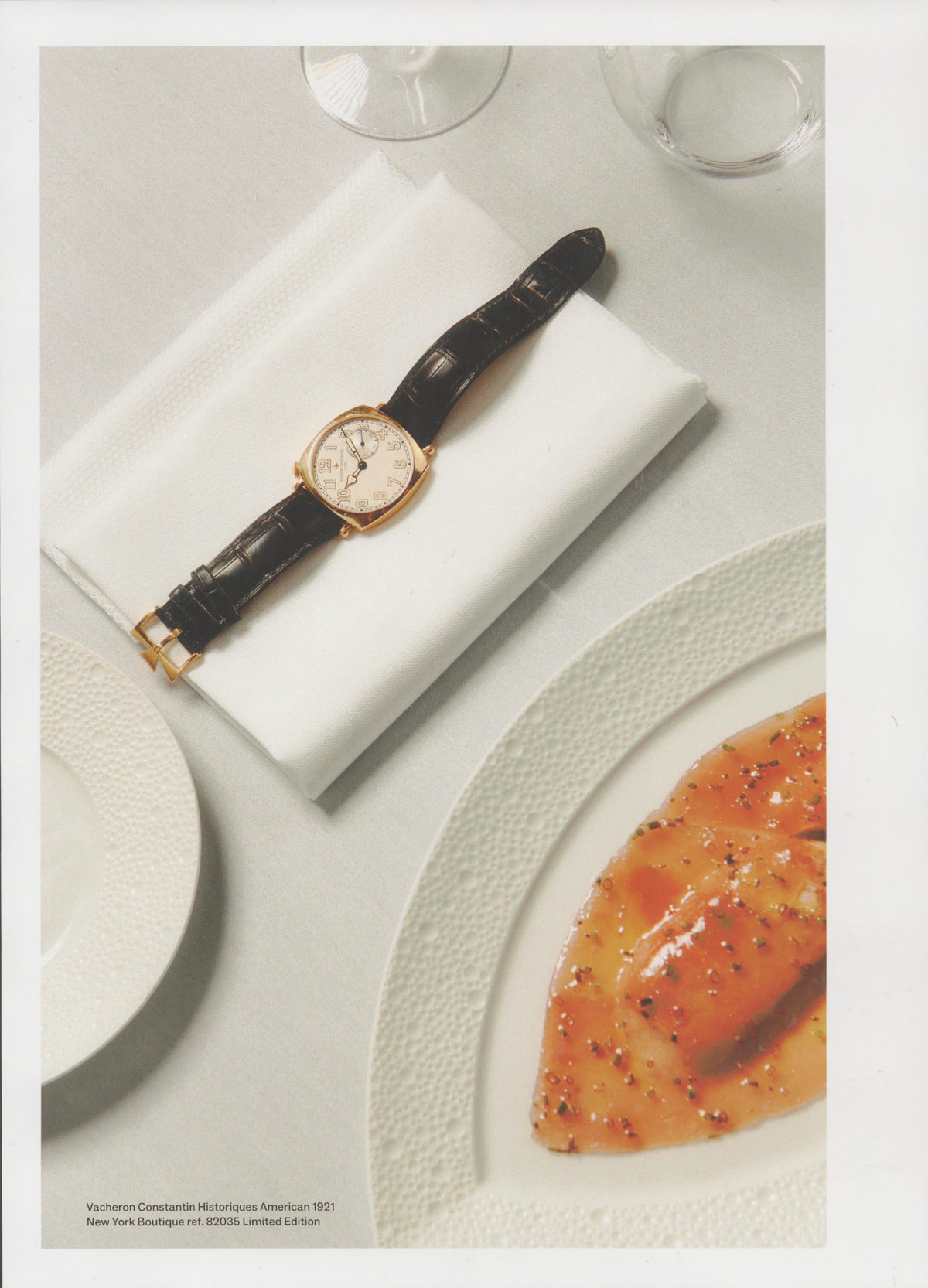 Vintage 1990s Vacheron Constantin Historiques American 1921 original print advertisement, yellow gold cushion-case watch on white linen napkin at fine dining table setting