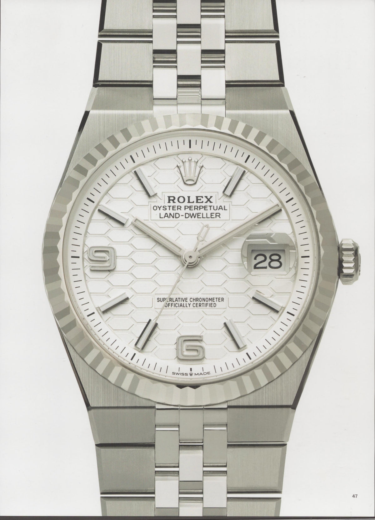 Vintage 1990s Rolex Oyster Perpetual Land-Dweller original print advertisement, close-up studio shot of stainless steel watch with honeycomb dial, fluted bezel, and Jubilee bracelet on white background