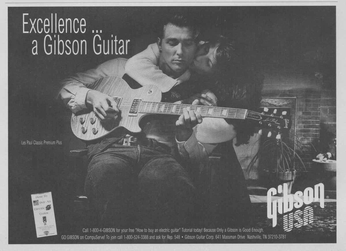 Vintage 1990s Gibson Les Paul Classic Premium Plus original print advertisement, black and white photo of man playing guitar with woman beside him, fireplace in background