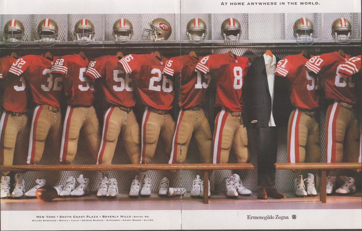 Vintage 1995 Ermenegildo Zegna original print advertisement, San Francisco 49ers players in locker room with suit hanging among football uniforms