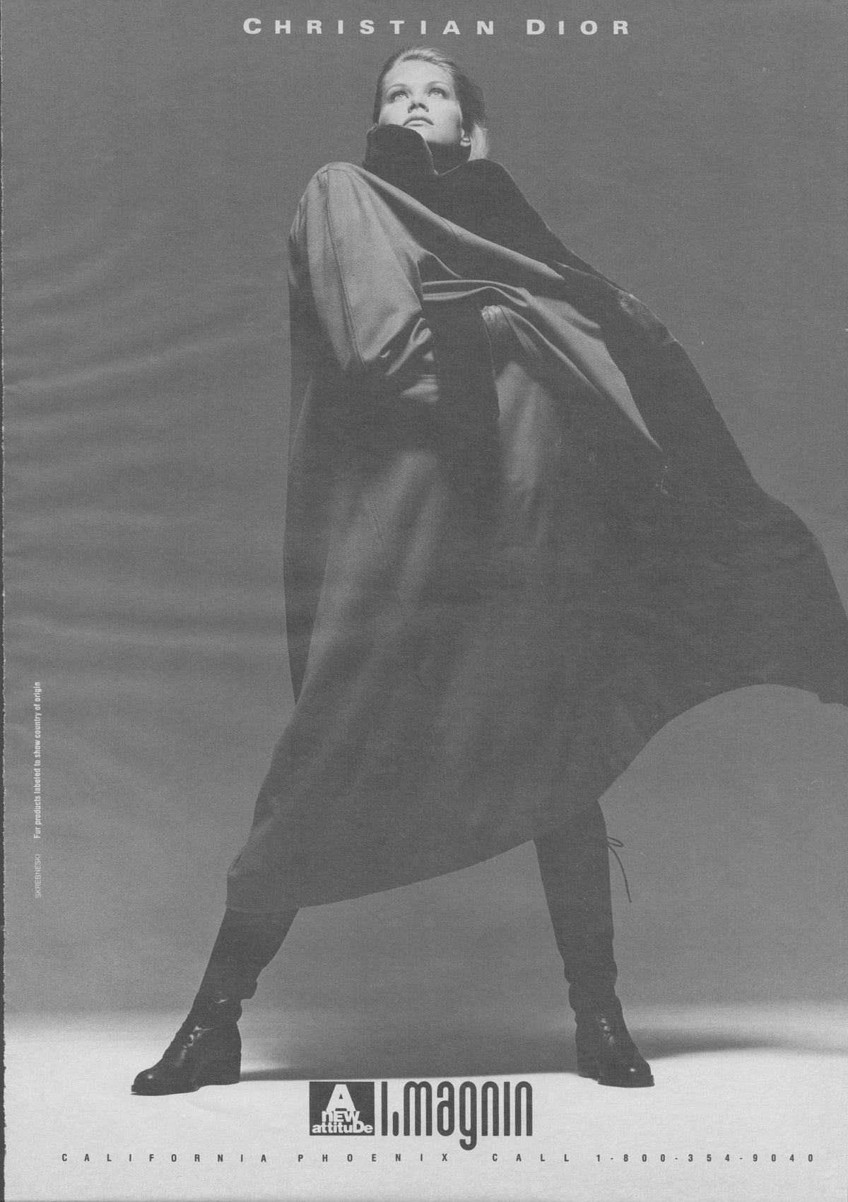 Vintage 1980s Christian Dior original print advertisement, black and white studio photograph of model in dramatic sweeping cape and tall boots, I. Magnin retailer ad