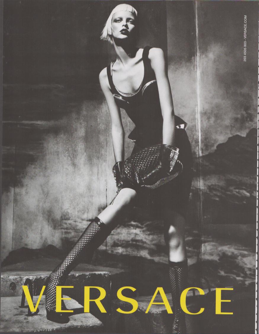 Vintage 2003 Versace original print advertisement, black and white editorial image of platinum-blonde model in bodysuit and fishnet boots with bold yellow Versace logo