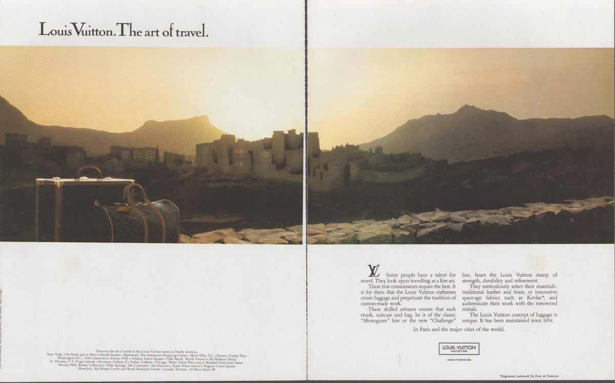 Vintage 1980s Louis Vuitton The Art of Travel original print advertisement, two-page spread featuring monogram luggage against a golden-hour desert cityscape
