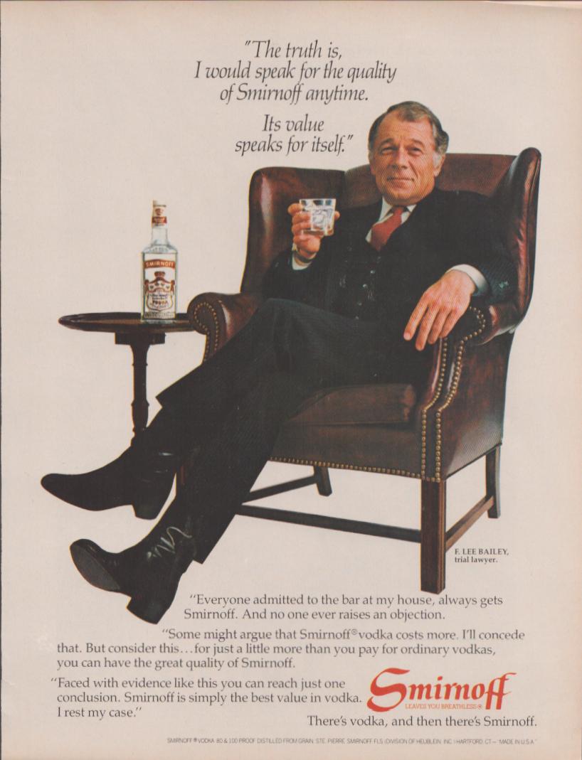 Vintage 1970s Smirnoff Vodka original print advertisement, F. Lee Bailey seated in leather wingback chair holding a glass with Smirnoff bottle on side table