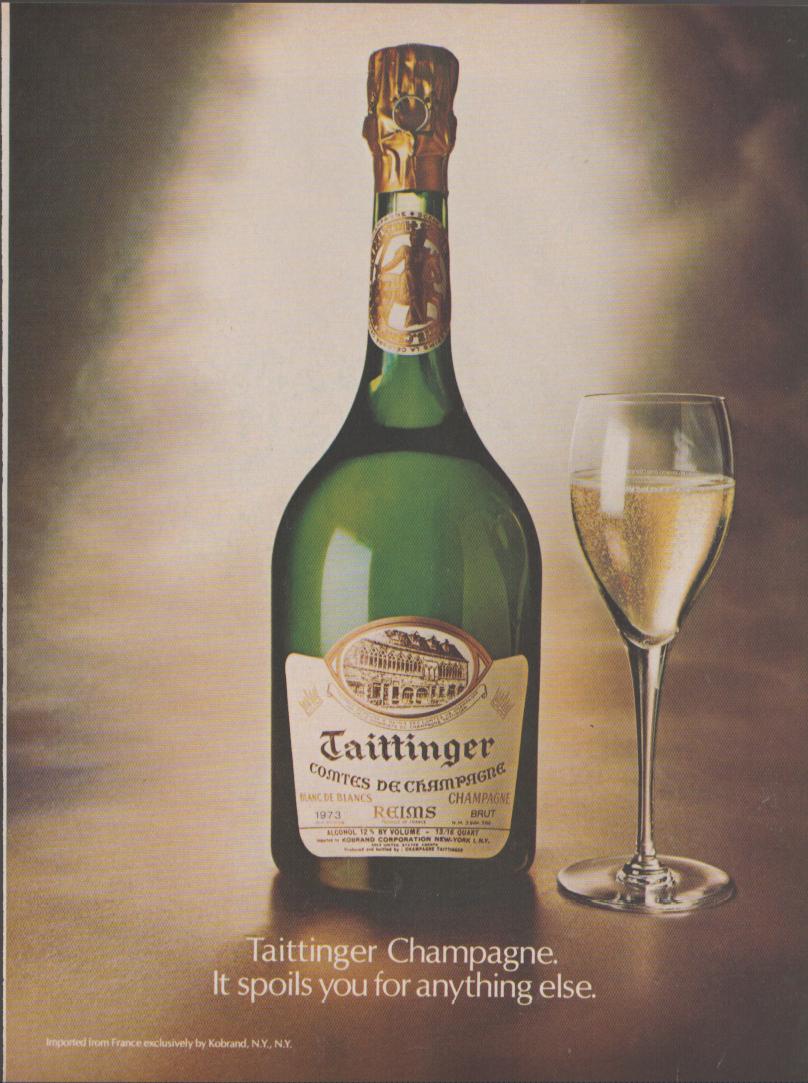 Vintage 1973 Taittinger Comtes de Champagne Blanc de Blancs original print advertisement, warm-toned studio photo of green bottle beside a filled champagne flute with tagline 'It spoils you for anything else'