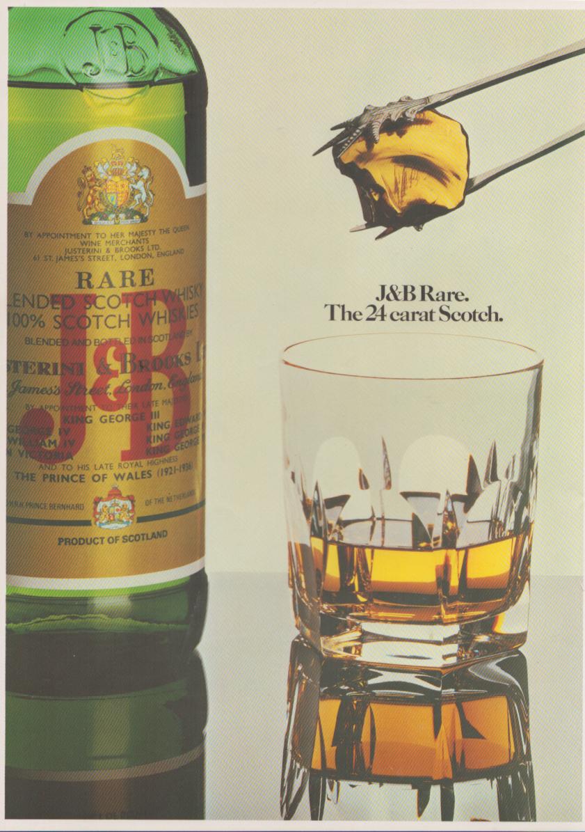 Vintage 1970s J&B Rare Scotch Whisky original print advertisement, jeweler's tongs holding golden drop over cut-crystal glass beside iconic green J&B bottle