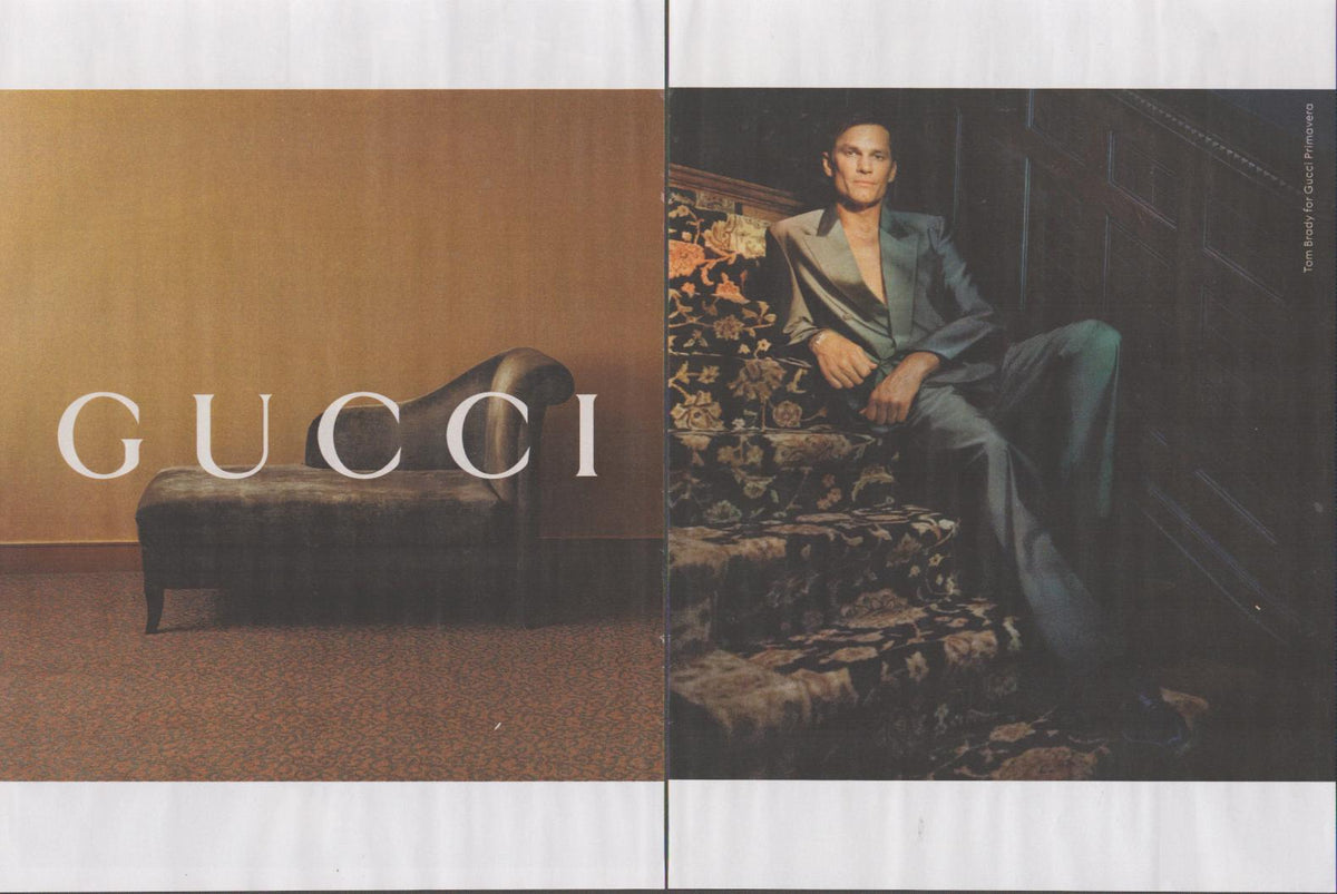 Vintage 2000s Gucci Primavera original print advertisement, male model in metallic suit reclining on ornate chaise lounge, two-page spread