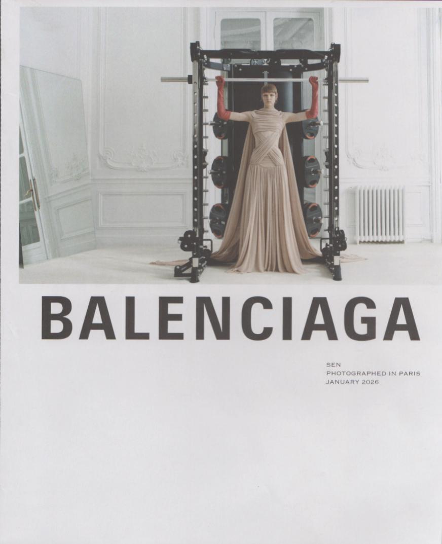 Vintage 2026 Balenciaga Couture original print advertisement, model in draped beige gown with red gloves standing in a weight rack in a Parisian interior