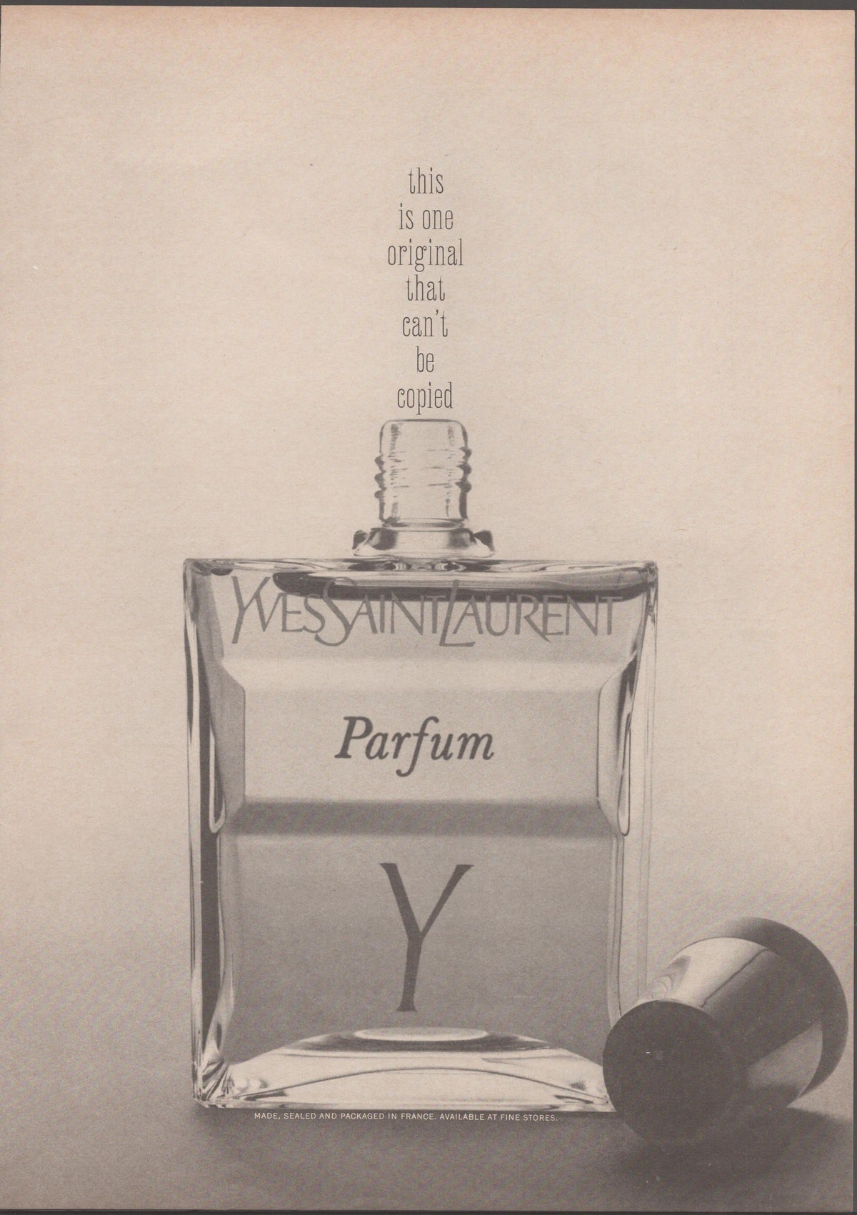 Vintage 1964 Yves Saint Laurent Y Parfum original print advertisement, black and white close-up of iconic square glass fragrance bottle with stopper beside it and headline 'this is one original that can't be copied'