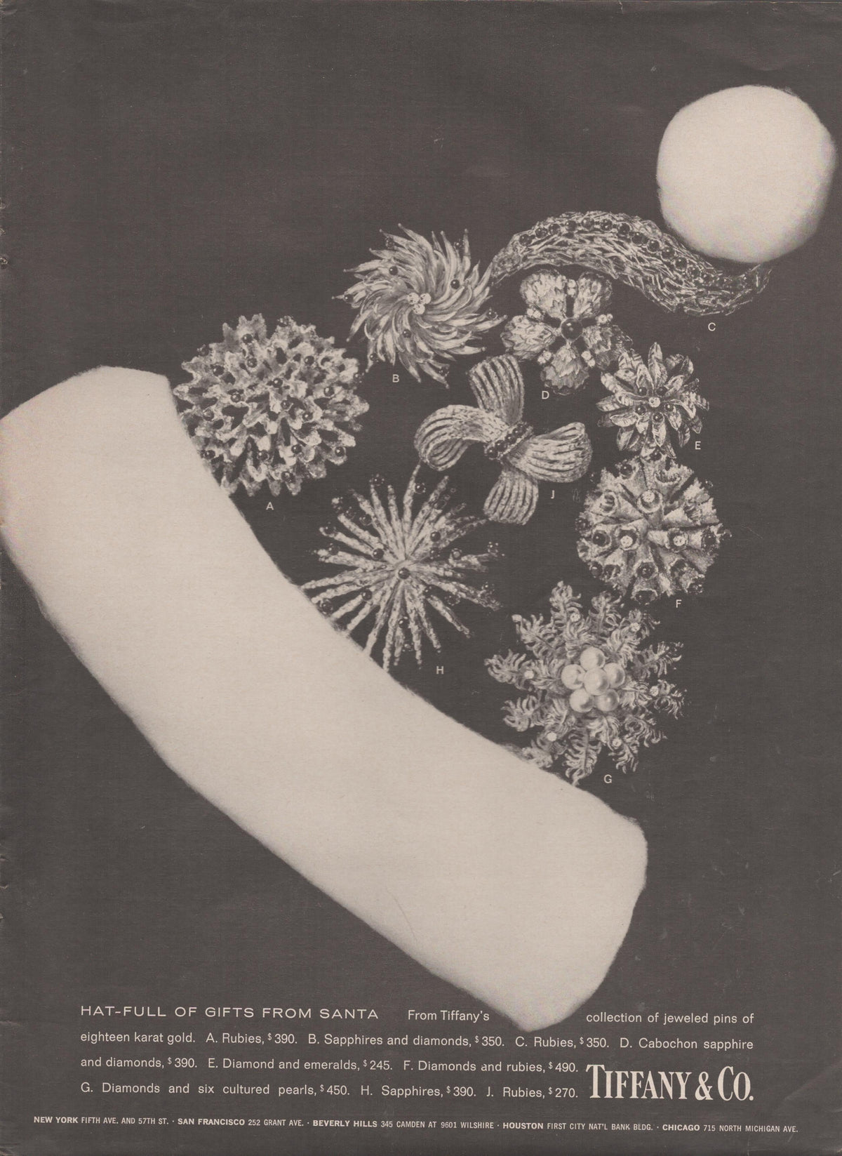Vintage 1960s Tiffany & Co. original print advertisement, black and white image of eighteen-karat gold jeweled pins arranged inside a Santa Claus hat on dark background
