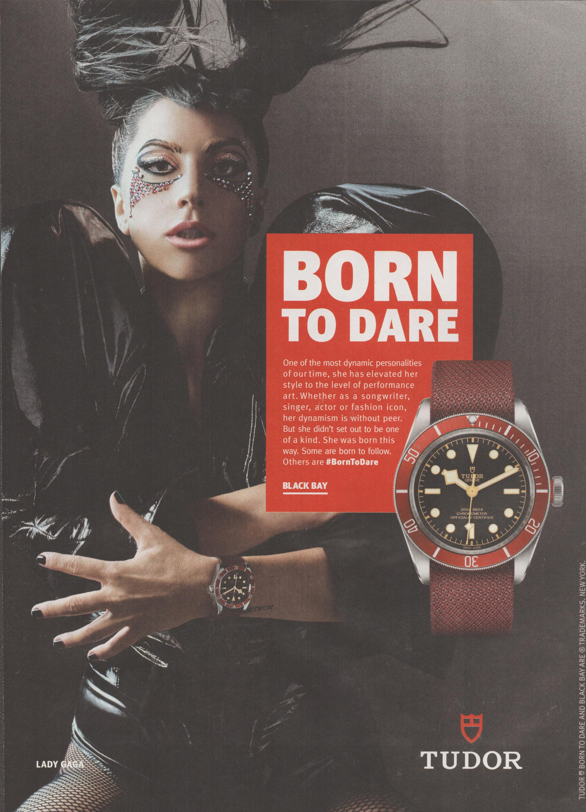 Vintage 2017 Tudor Black Bay original print advertisement, Lady Gaga wearing red-bezel Black Bay watch with dramatic avant-garde makeup and styling, Born to Dare campaign