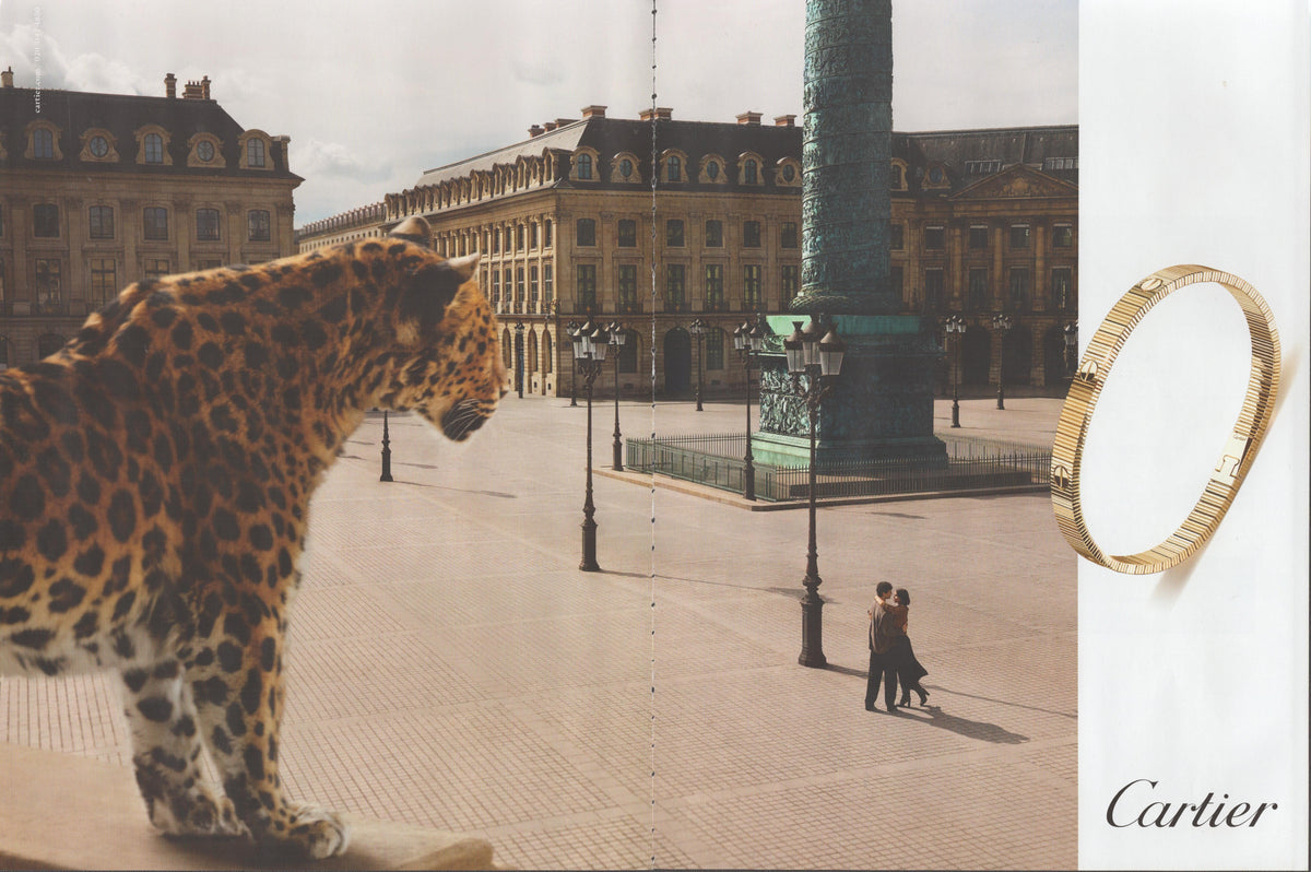 Vintage 1980s Cartier gold bracelet original print advertisement, leopard in foreground overlooking Place Vendôme Paris with couple and Vendôme Column