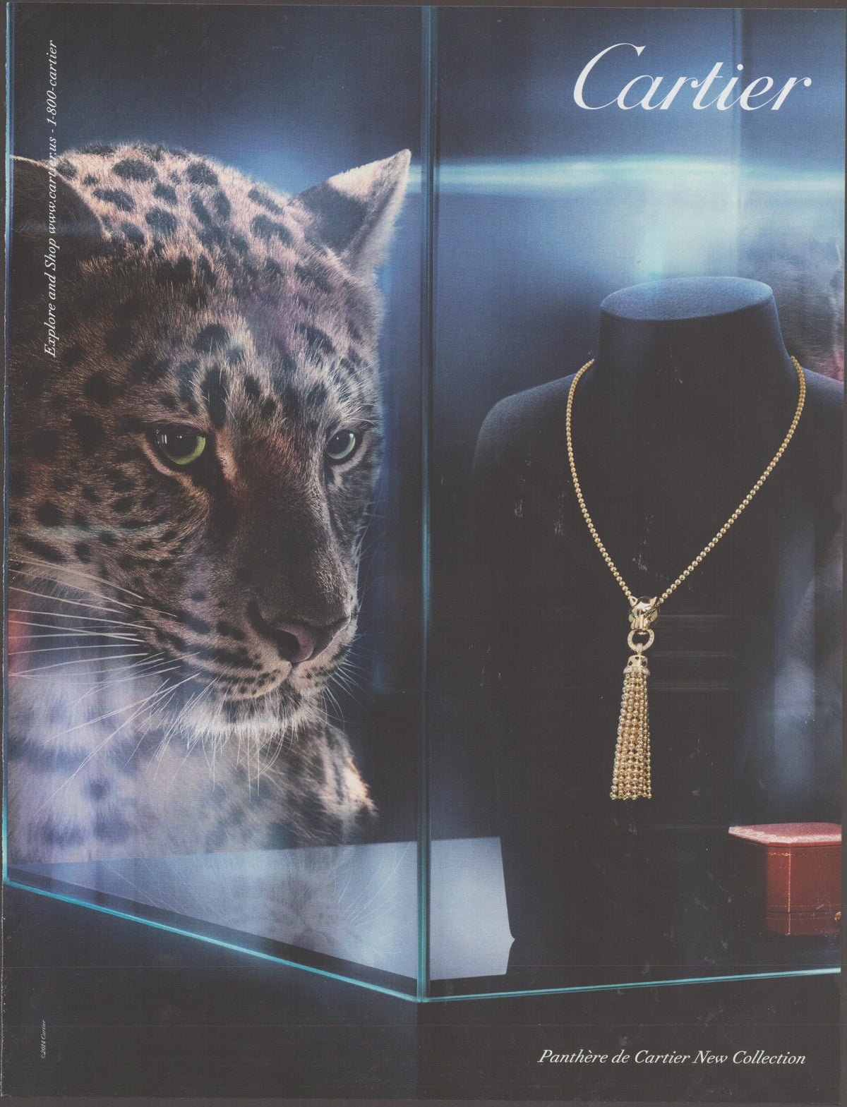 Vintage 2002 Cartier Panthère de Cartier original print advertisement, leopard gazing through glass vitrine at gold tassel necklace on velvet bust with red Cartier box