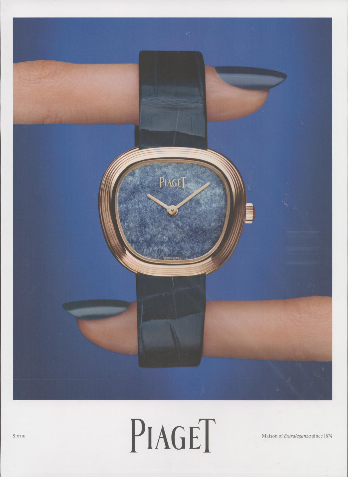 Vintage 2010s Piaget Sixtie original print advertisement, rose gold cushion-case watch with lapis lazuli dial held between two manicured fingers against cobalt blue background