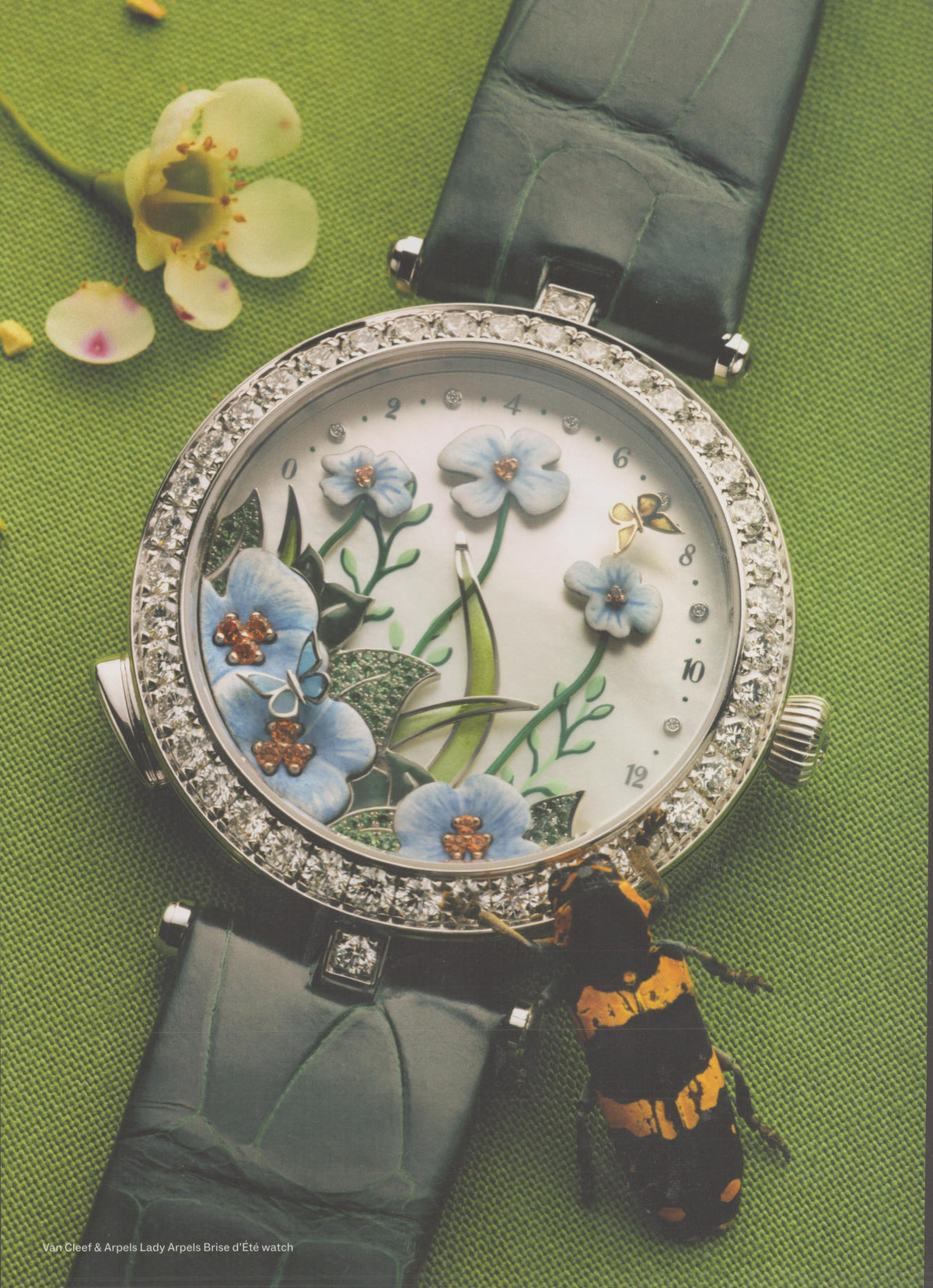 Vintage 2000s Van Cleef & Arpels Lady Arpels Brise d'Été original print advertisement, close-up of diamond-bezel watch with hand-enameled floral dial on green background with bumblebee prop