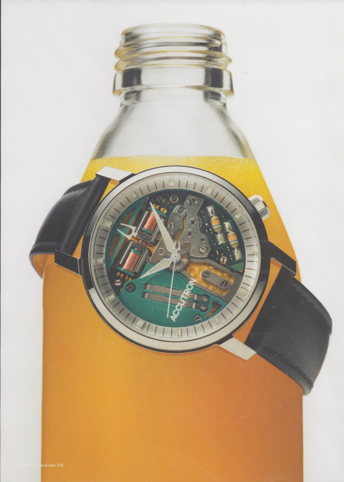 Vintage 1972 Bulova Accutron Spaceview 314 original print advertisement, skeleton dial watch with exposed teal movement draped over amber glass bottle on white background