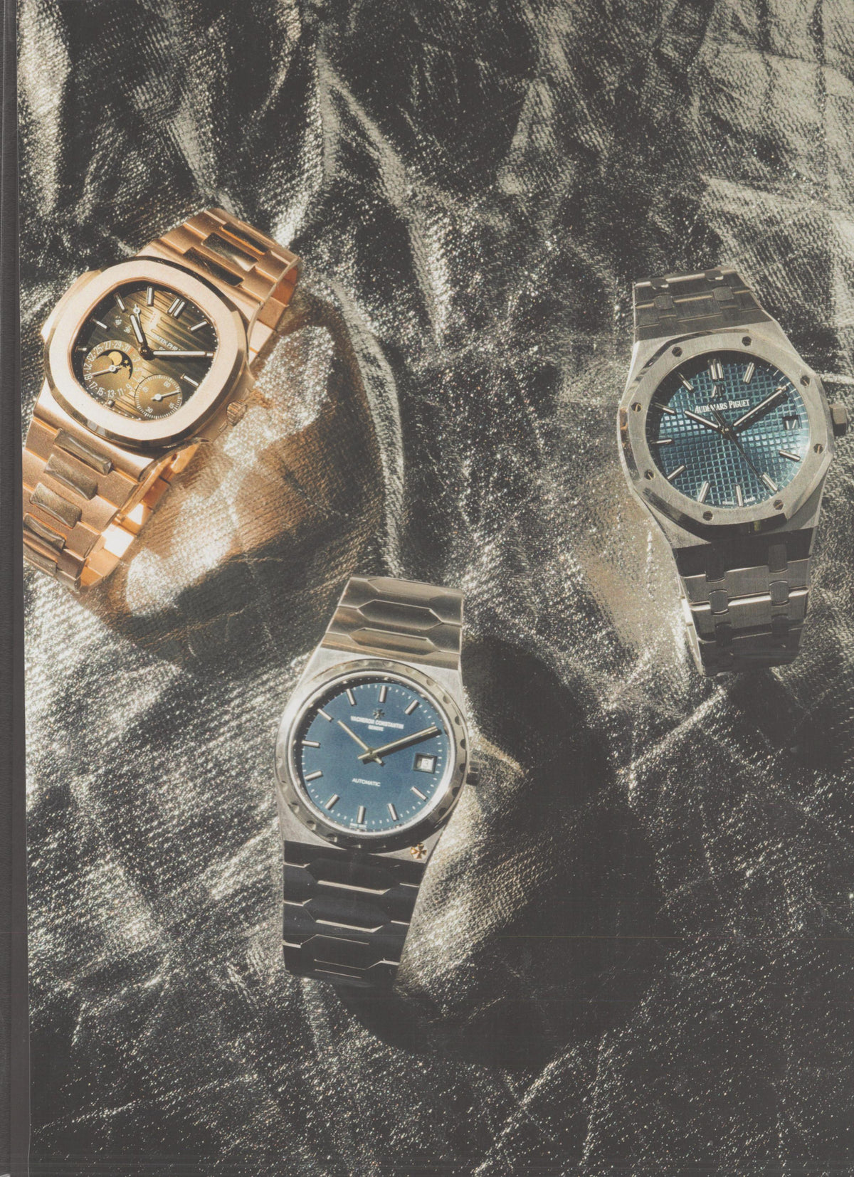 Vintage 1970s Audemars Piguet Royal Oak original print advertisement, three luxury sport watches — Royal Oak, Patek Nautilus, and Vacheron 222 — arranged on silver fabric background