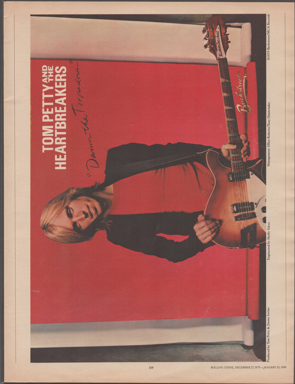 Vintage 1979 Tom Petty and the Heartbreakers original print advertisement, Tom Petty holding a Rickenbacker guitar against a bold red background promoting Damn the Torpedoes