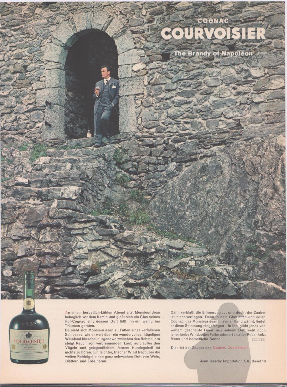 Vintage 1960s Courvoisier Cognac VSOP original print advertisement, elegantly dressed man holding a cognac snifter standing in arched stone castle doorway overlooking vineyard landscape