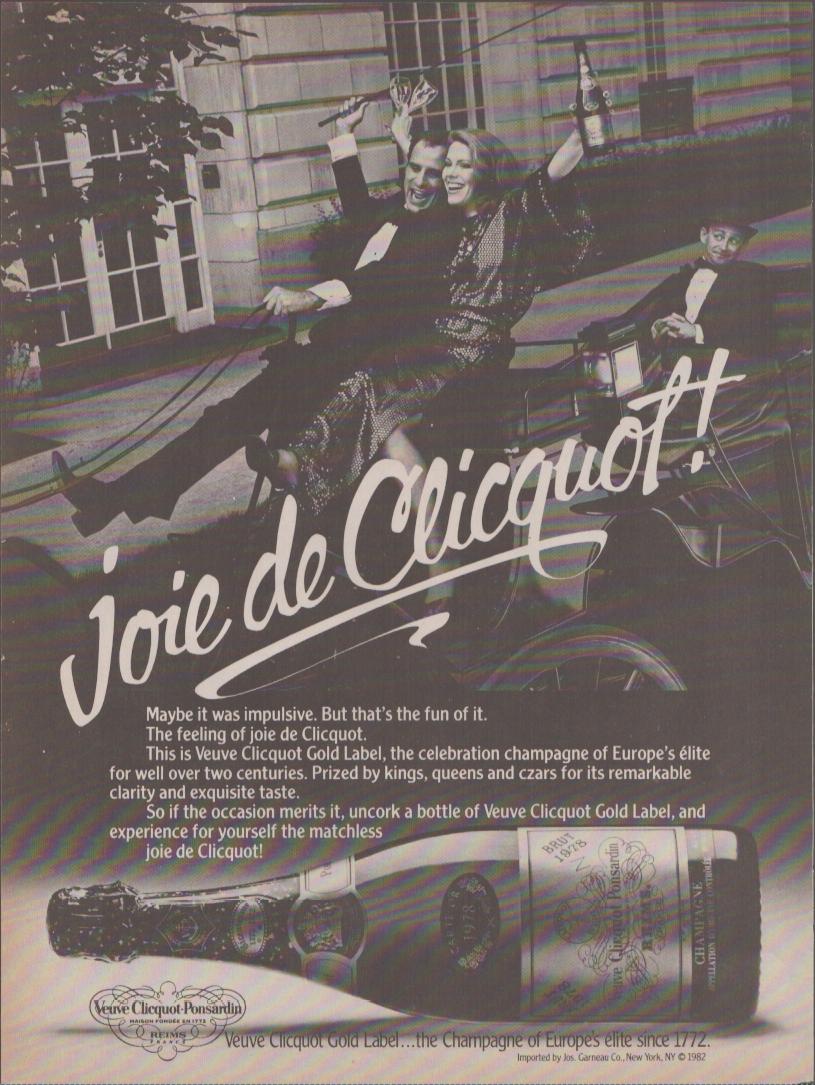 Vintage 1982 Veuve Clicquot Gold Label original print advertisement, black and white image of glamorous couple celebrating in the street with champagne bottle, Joie de Clicquot script headline