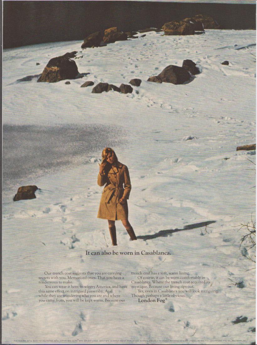 Vintage 1960s London Fog trench coat original print advertisement, woman walking alone across a snowy rocky landscape with headline 'It can also be worn in Casablanca'