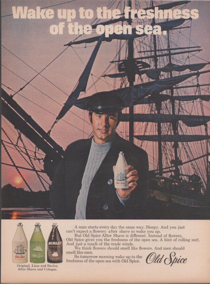 Vintage 1960s Old Spice After Shave original print advertisement, sailor holding Old Spice bottle in front of tall ship at sunset