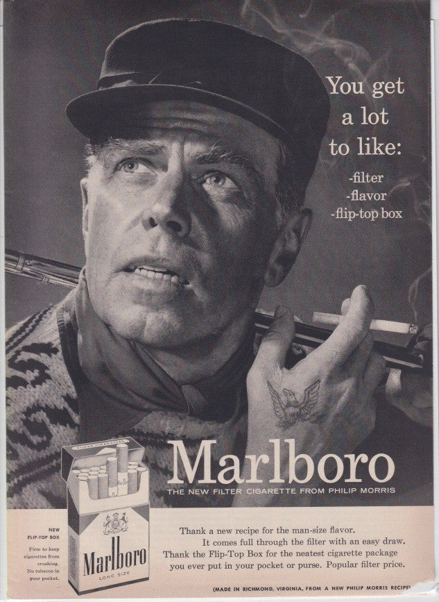 Vintage 1955 Marlboro cigarette original print advertisement, black and white close-up of rugged tattooed man smoking with flip-top box packaging shown below