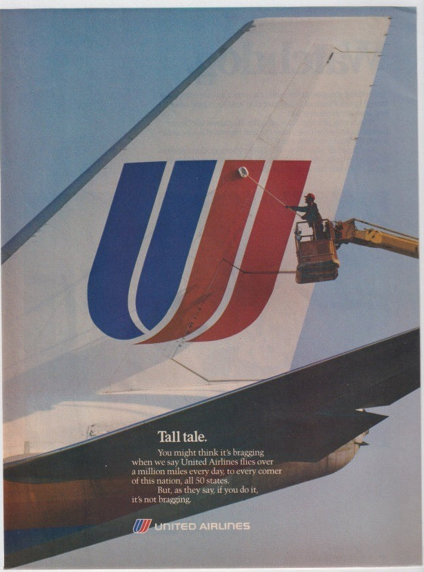 Vintage 1980s United Airlines original print advertisement, worker on cherry-picker polishing iconic blue and red tulip logo on large aircraft tail fin against blue sky