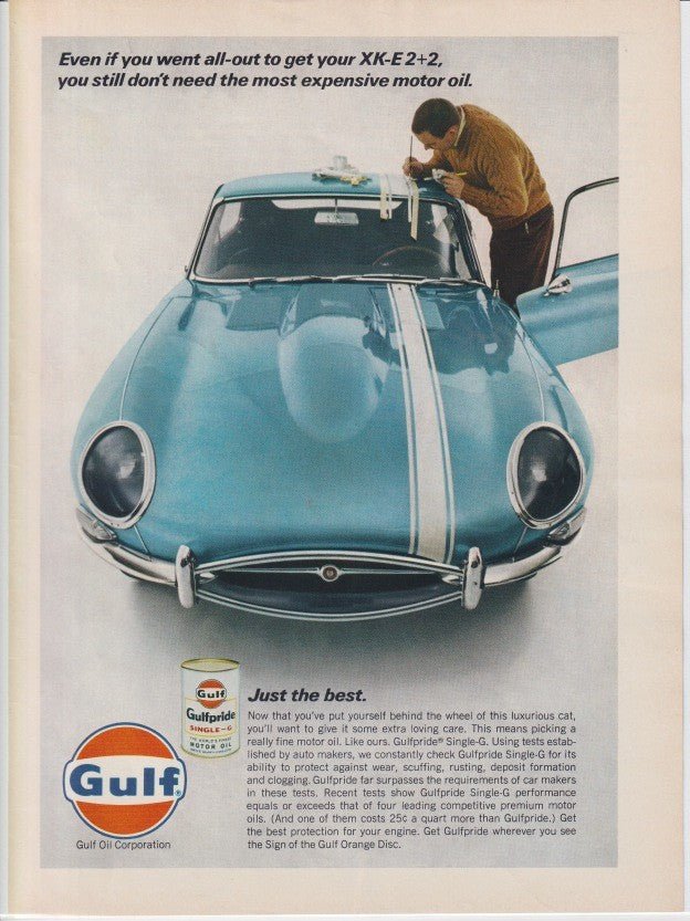 Vintage 1967 Jaguar XK-E 2+2 Gulf Gulfpride motor oil original print advertisement, aqua E-Type coupe viewed from front angle with man tending to engine