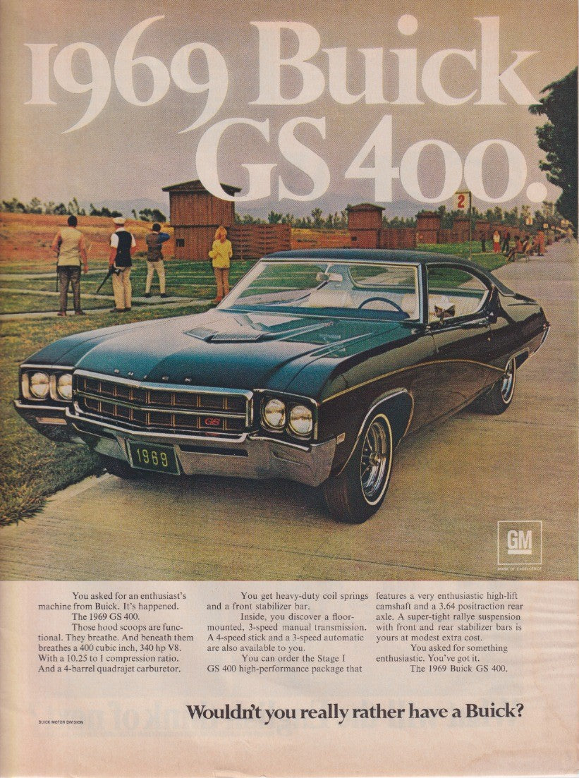 Vintage 1969 Buick GS 400 original print advertisement, dark green muscle car hardtop parked at a sporting venue with spectators in background