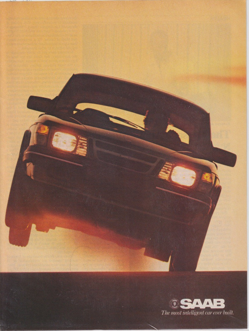 Vintage 1985 Saab 900 Convertible original print advertisement, dramatic low-angle golden-hour shot of car cresting a rise with headlights on