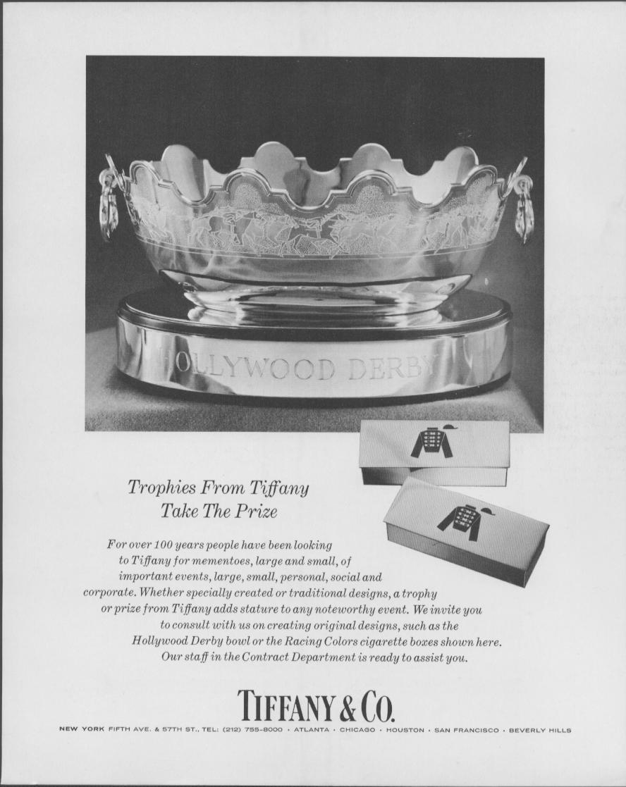 Vintage 1960s Tiffany & Co. original print advertisement, black and white photo of sterling silver Hollywood Derby trophy bowl with engraved horse frieze and Racing Colors cigarette boxes