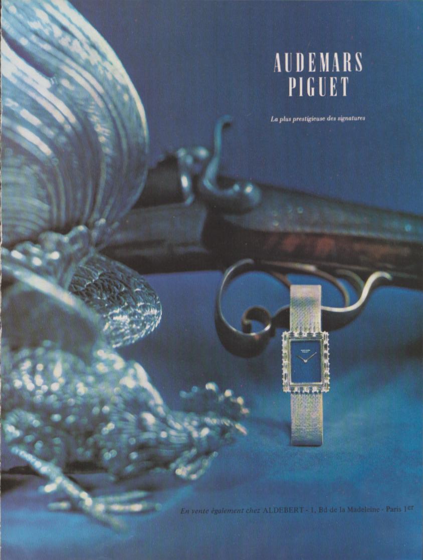 Vintage 1970s Audemars Piguet ladies diamond bracelet watch original print advertisement, blue-toned still life with silver game bird sculpture and antique shotgun