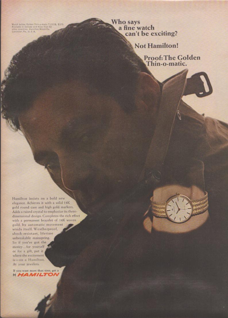 Vintage 1960s Hamilton Golden Thin-o-matic original print advertisement, dramatic close-up of man in trench coat displaying gold woven bracelet watch on raised wrist